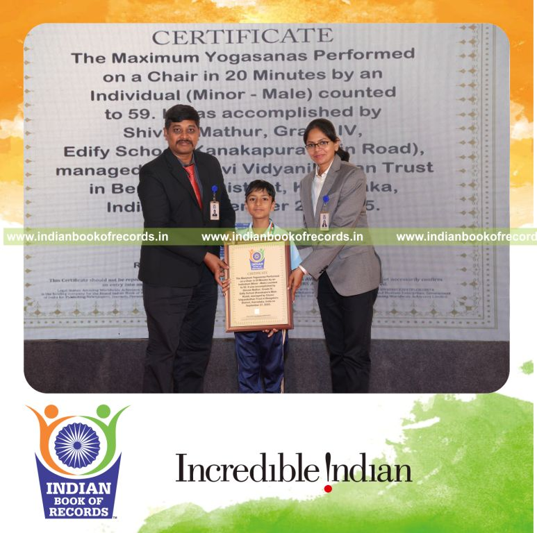 Young boy performing multiple yogasanas on a chair within a timed session recognized by Indian Book of Records