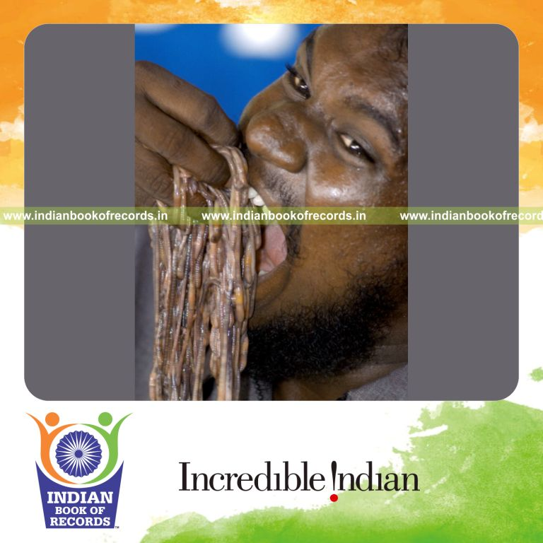 male individual attempting fastest time to swallow 200 worms for record in Indian Book of Records