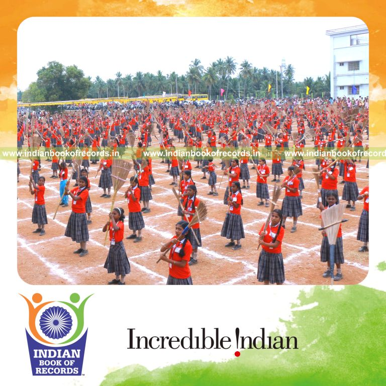 Large group performing a coordinated broom dance at one venue recognized by Indian Book of Records