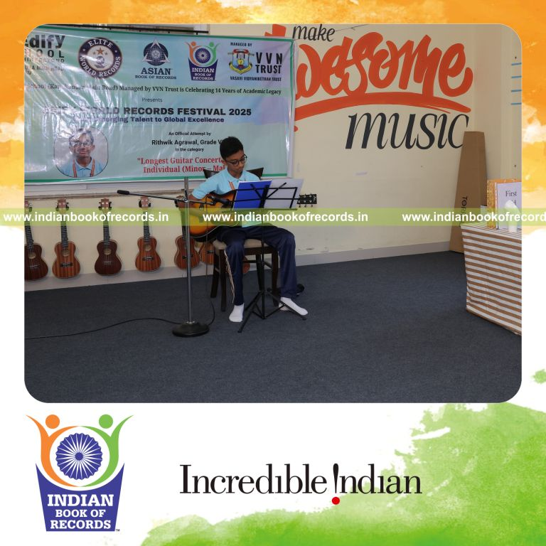 Young boy performing continuously in a long guitar concert recognized by Indian Book of Records