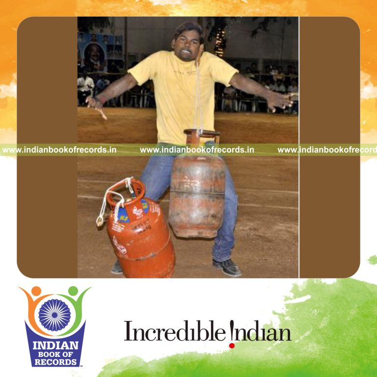 male individual lifting heavy objects using ears for record in Indian Book of Records