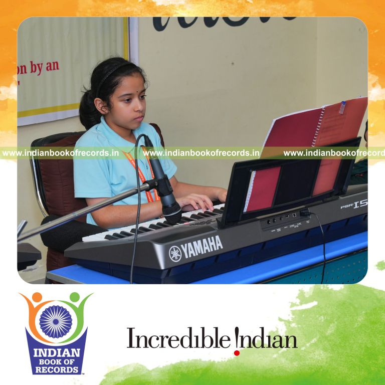 Young girl performing continuously on a keyboard during a long concert recognized by Indian Book of Records