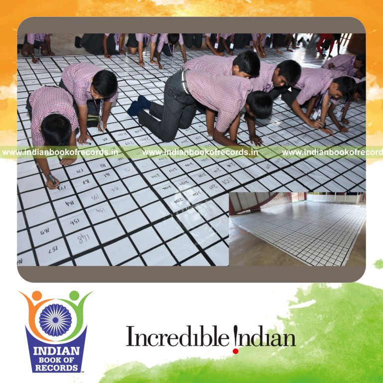 Participants simultaneously solving a large 49x49 magic square puzzle replica recognized by Indian Book of Records