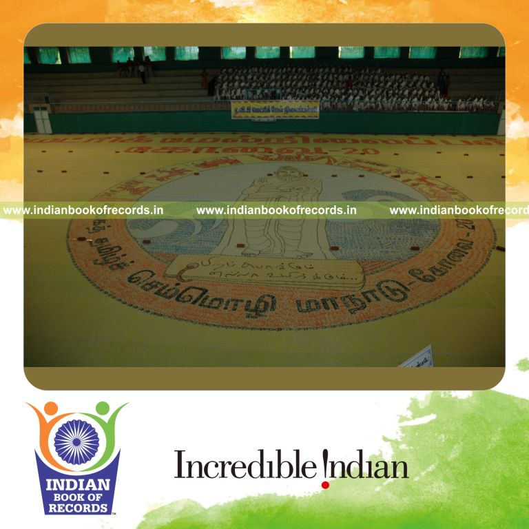 three generations creating large finger painting for record in Indian Book of Records