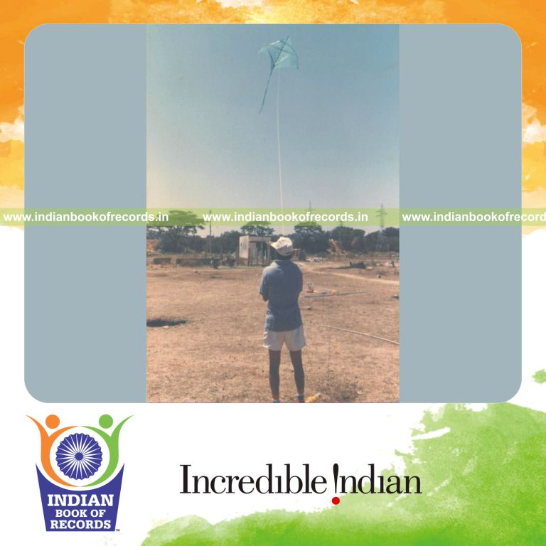 male individual flying a large kite single handedly for record in Indian Book of Records