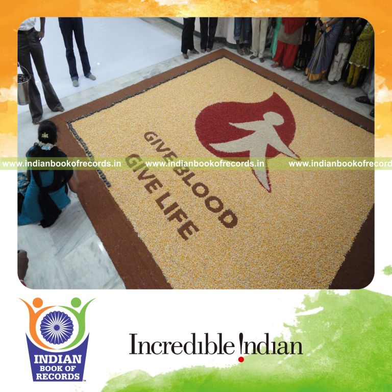 female artist creating large mosaic artwork using seeds for record in Indian Book of Records