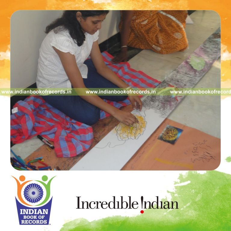female artist creating an extended drawing for record achievement in Indian Book of Records