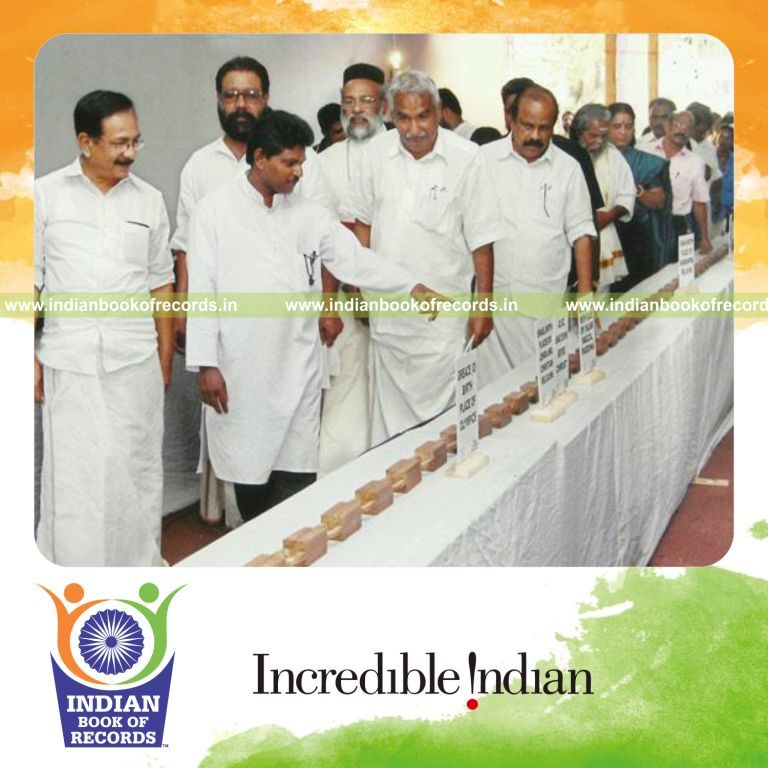 male individual creating long handmade wooden linked chain for record in Indian Book of Records