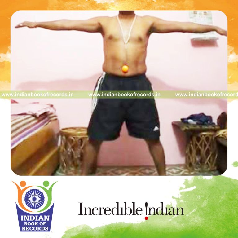 individual holding star pose with table tennis ball on navel for record in Indian Book of Records
