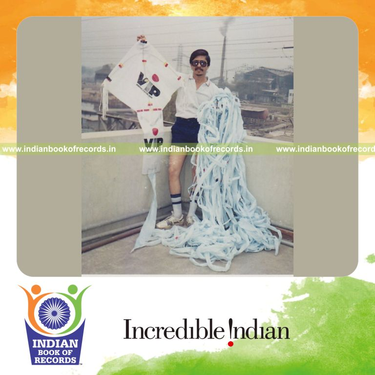 male individual flying kite using extremely long thread for record in Indian Book of Records