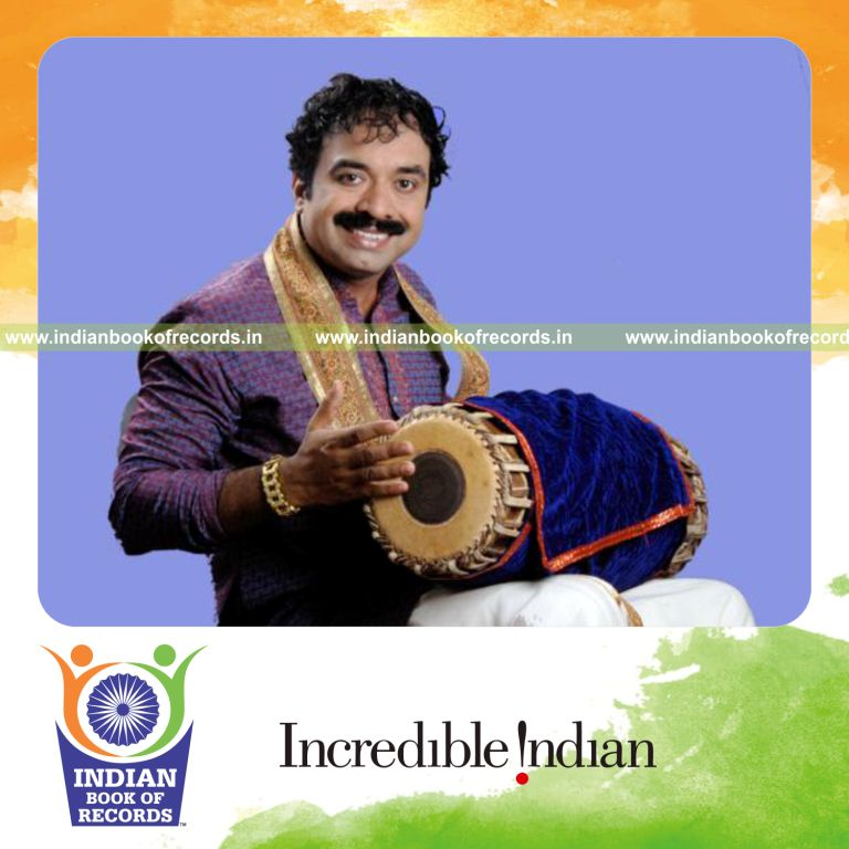 male individual playing mridangam continuously for extended duration for record in Indian Book of Records