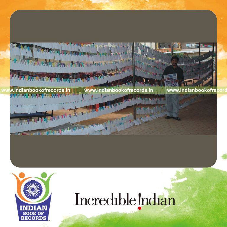 male individual signing autographs on photographs within one hour for record in Indian Book of Records