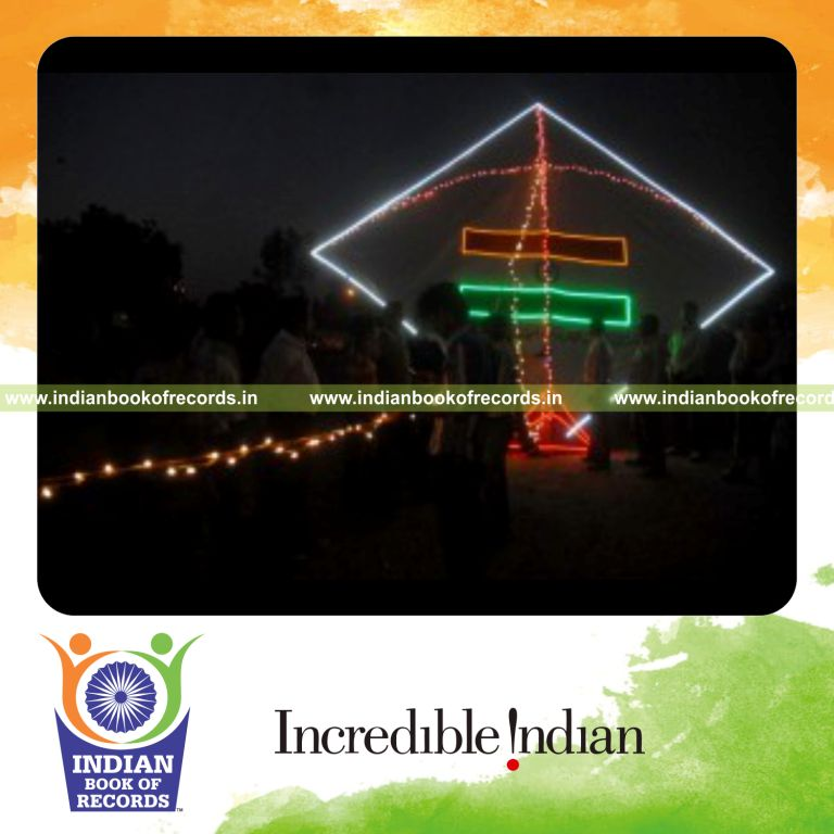 male individual attaching multiple electric tukkals on a single kite for record in Indian Book of Records