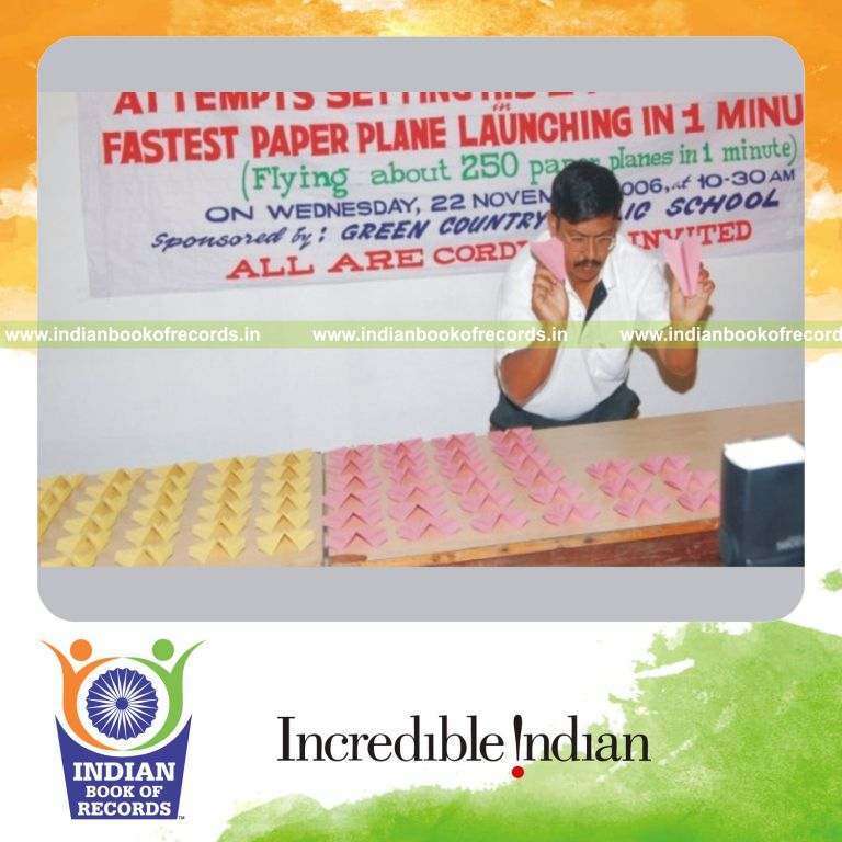 male individual launching multiple paper planes within one minute for record in Indian Book of Records