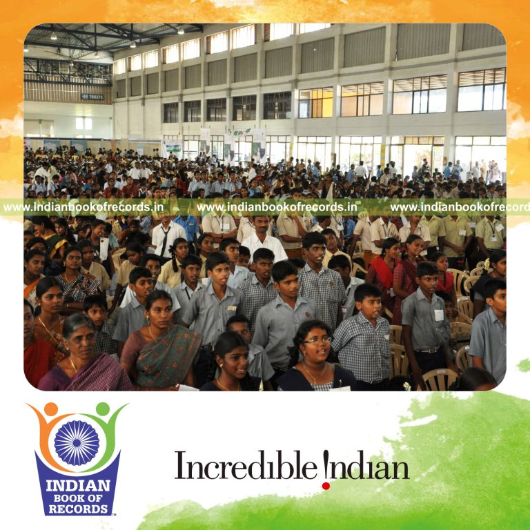 group of people reading aloud simultaneously at single venue for record in Indian Book of Records