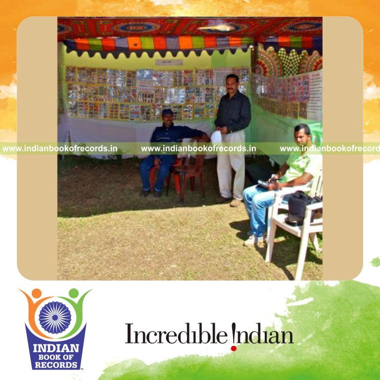 male individual collecting multiple telephone cards for record in Indian Book of Records