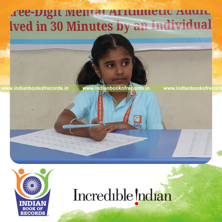 Young girl solving three-digit addition problems in rows during a timed session recognized by Indian Book of Records