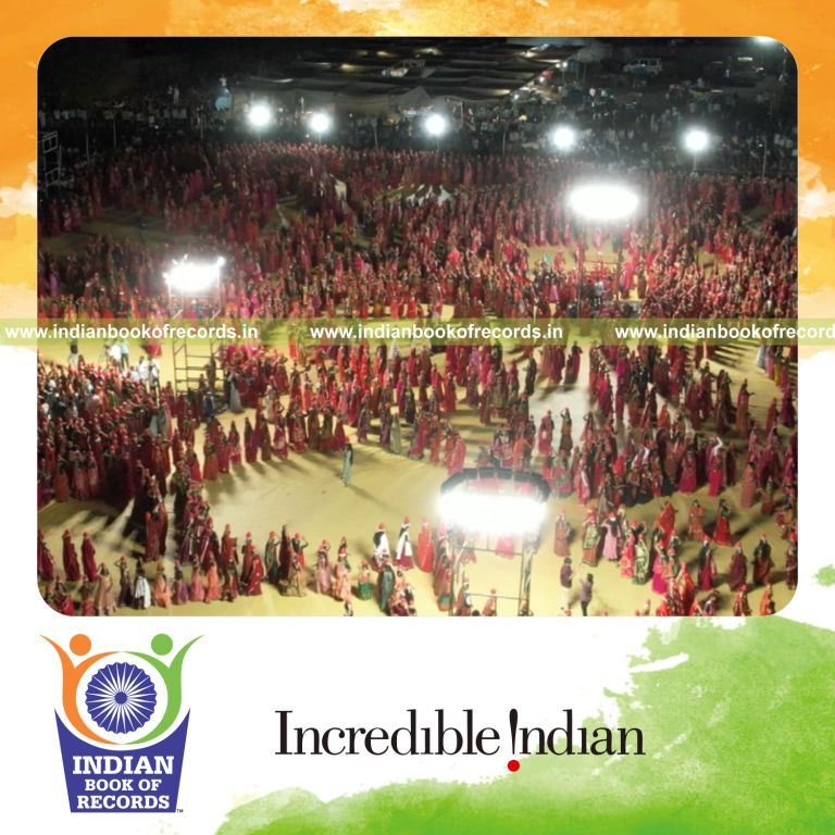 Women performing Sheri Garba dance while balancing pots on their heads in a large coordinated event recognized by Indian Book of Records