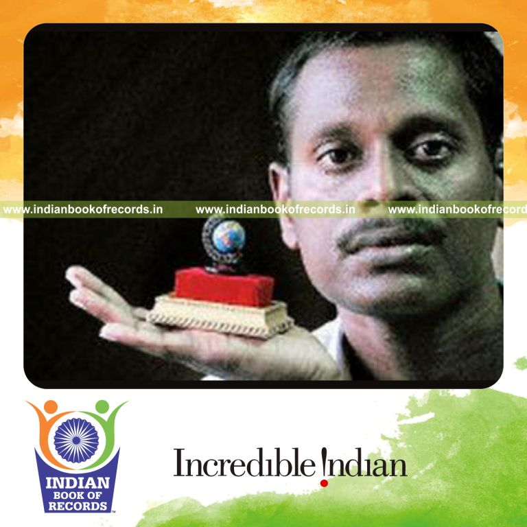 male individual creating a very small handmade globe for record in Indian Book of Records
