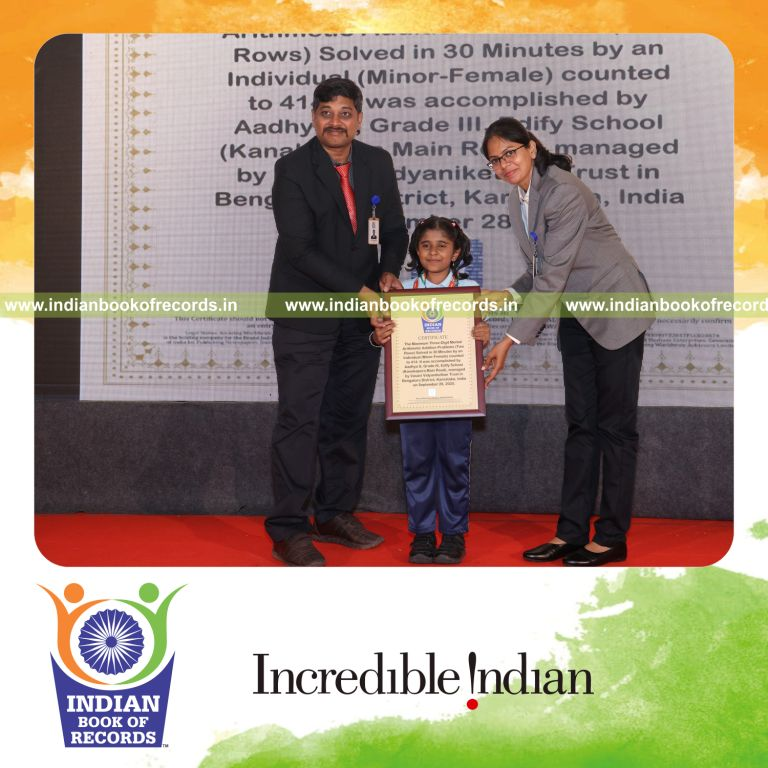 Young girl solving three-digit addition problems in rows within a timed session recognized by Indian Book of Records