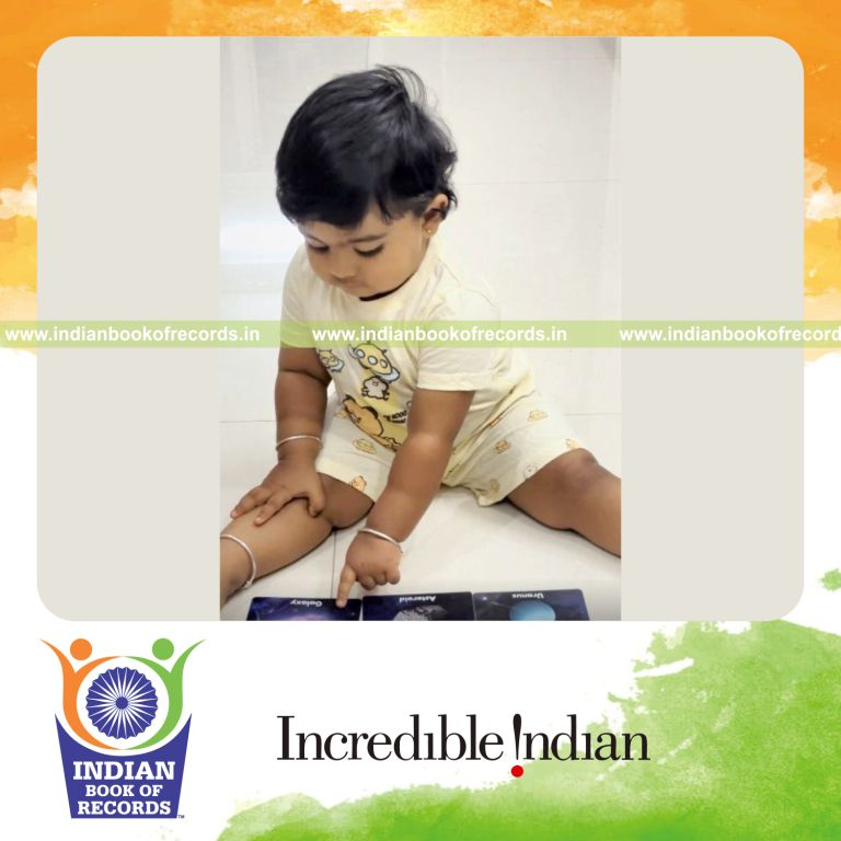 Toddler recognizing space-themed images using flashcards during a timed activity recognized by Indian Book of Records