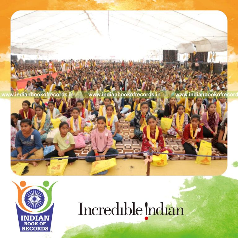 Large group of women receiving Katar Indian daggers in a ceremonial event recognized by Indian Book of Records