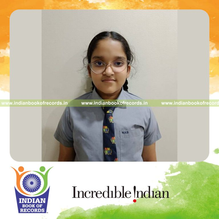 Young girl holding her published poetry book as a record achievement recognized by Indian Book of Records